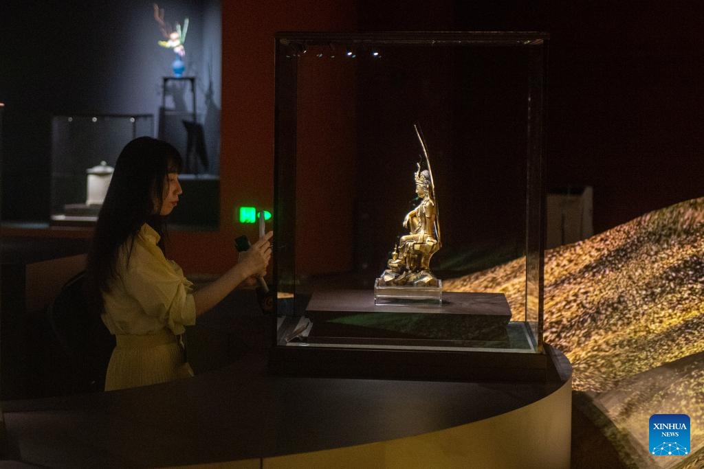 A visitor takes photos of an exhibit during an exhibition of the sixth World Buddhist Forum in Ningbo, east China's Zhejiang Province, Oct. 15, 2024. (Photo: Xinhua)