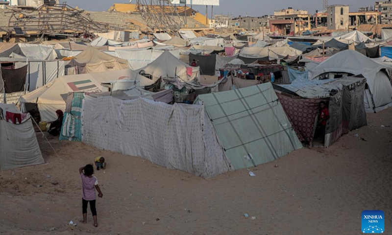 Displaced Palestinians are seen at a temporary shelter in the southern Gaza Strip city of Khan Younis, on Oct. 15, 2024. (Photo: Xinhua)