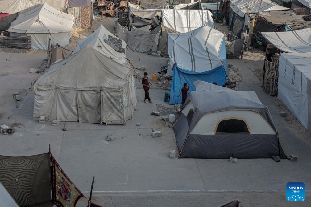 Displaced Palestinian children are seen at a temporary shelter in the southern Gaza Strip city of Khan Younis, on Oct. 15, 2024. (Photo: Xinhua)