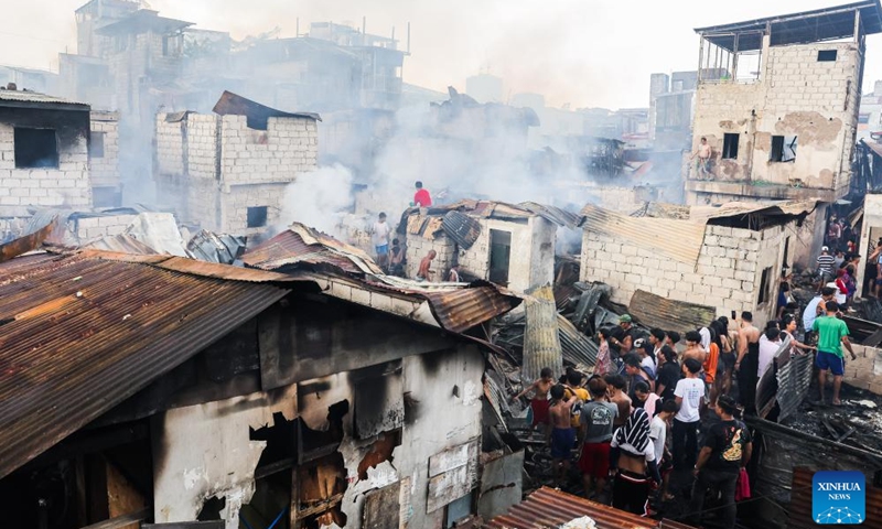 Residents return to their charred homes after a fire at a slum area in Manila, the Philippines, on Oct. 15, 2024. (Photo: Xinhua)