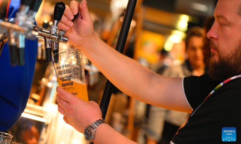 A man pours beer from a tap at the Warsaw Beer Festival in Warsaw, Poland, on Oct. 17, 2024. (Photo: Xinhua)