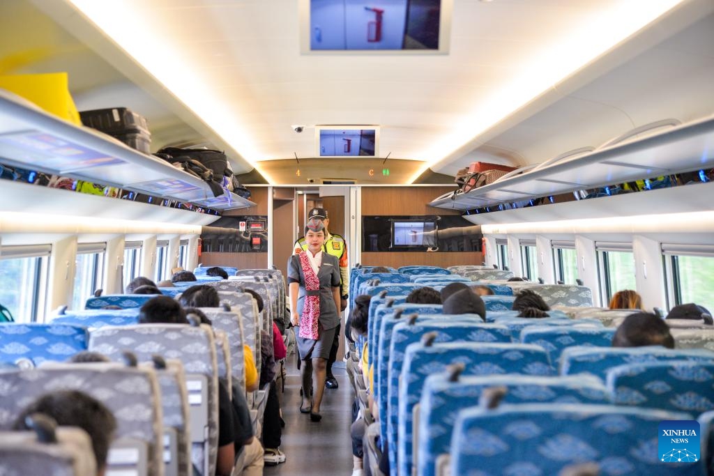 Train cabin crew members walk in a running high-speed electrical multiple unit (EMU) train of the Jakarta-Bandung High-Speed Railway (HSR) in Indonesia, Oct. 17, 2024. The Jakarta-Bandung HSR, celebrating its first anniversary on Thursday, has transported 5.79 million passengers, according to PT Kereta Cepat Indonesia-China (KCIC), a joint venture between Indonesian and Chinese enterprises that built and operates the railway. (Photo: Xinhua)