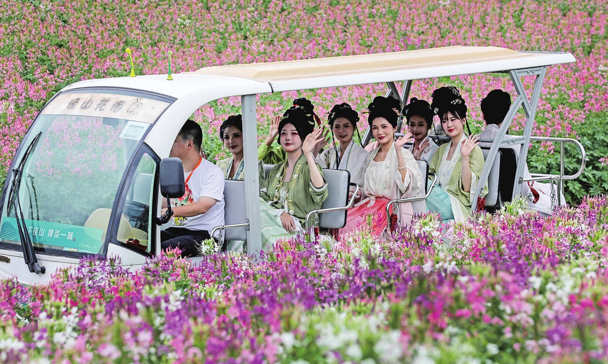 Visitors enjoy gorgeous scenery in a flower field, wearing hanfu costumes in Jingshan town, East China's Zhejiang Province. Photo: VCG