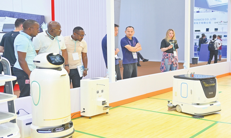 Overseas buyers explore intelligent robots displayed at a booth of the 136th Canton Fair in Guangzhou, South China's Guangdong Province on October 17, 2024.  More than 8,000 exhibitors have been recognized as national high-tech enterprises, 