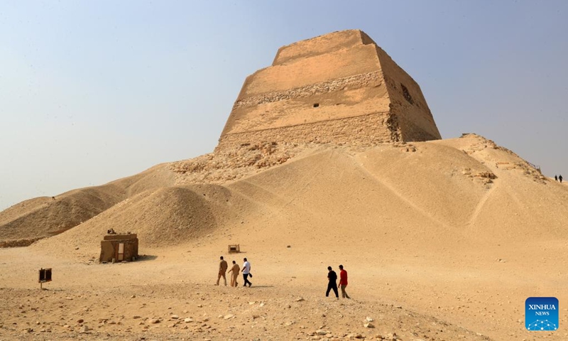 Tourists accompanied by staff members visit the Meidum Pyramid in Beni Suef Governorate, Egypt, Oct. 16, 2024. Meidum Pyramid is thought to be built by Pharaoh Sneferu, the first pharaoh of the Fourth Dynasty of ancient Egypt. The pyramid has a history of around 4,600 years. (Photo:Xinhua)