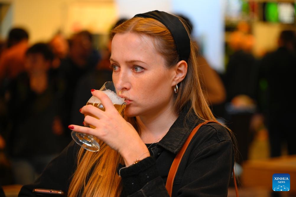 A woman enjoys beer at the Warsaw Beer Festival in Warsaw, Poland, on Oct. 17, 2024. (Photo: Xinhua)