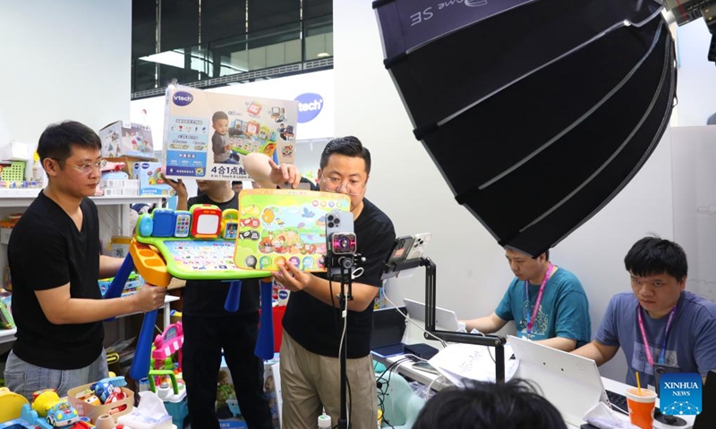 Staff of an exhibitor promote their products through live-streaming during the 2024 China Toy Expo in east China's Shanghai, Oct. 16, 2024. The three-day 2024 China Toy Expo kicked off at Shanghai New International Expo Centre Wednesday, attracting more than 2,500 companies of the toy industry from home and abroad. (Photo:Xinhua)