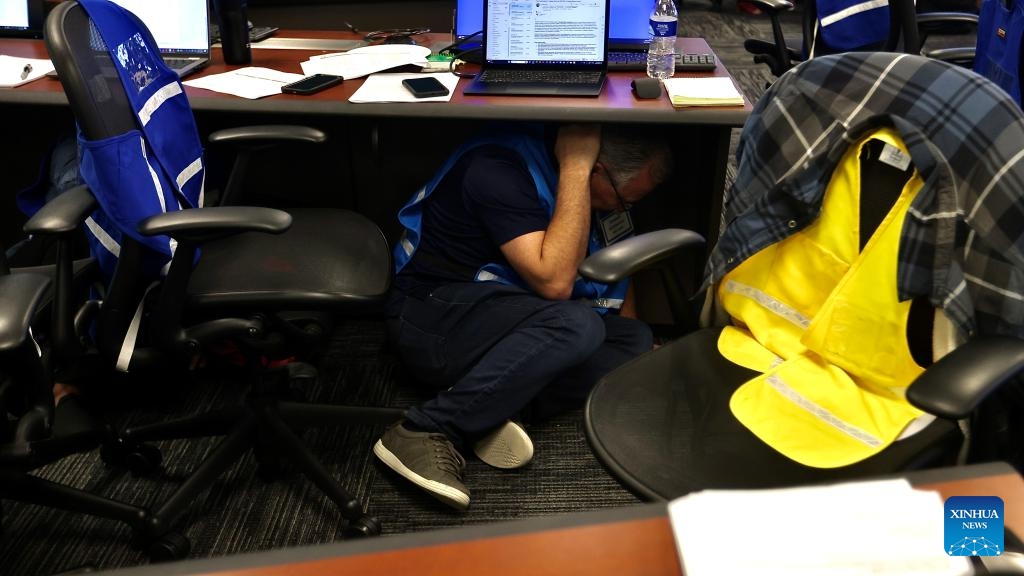 A man practices Drop, Cover and Hold On during an earthquake preparedness drill in Los Angeles County, California, the United States, on Oct. 17, 2024. (Photo: Xinhua)