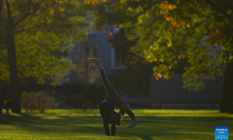 A girl does morning exercises at Lazienki Park in Warsaw, Poland, on Oct. 16, 2024. (Photo: Xinhua)