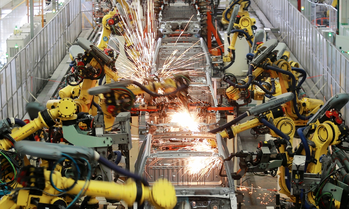 Industrial robots carry out welding operations in an intelligent workshop of an automobile manufacturer located in Jiangdu Hi-tech Industrial Development Zone, Yangzhou, East China's Jiangsu Province, on October 18, 2024. China's GDP grew 4.8 percent year on year in the first nine months of 2024, data from the National Bureau of Statistics (NBS) showed on the day. Photo: VCG