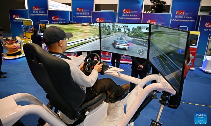 A man plays a virtual motor racing game during the 2024 China International Consumer Electronics Exposition in Qingdao, east China's Shandong Province, Oct. 18, 2024. The expo kicked off here on Friday. (Photo: Xinhua)