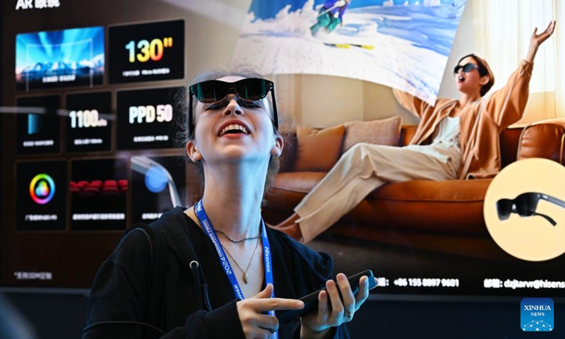 A woman tries a pair of AR glasses during the 2024 China International Consumer Electronics Exposition in Qingdao, east China's Shandong Province, Oct. 18, 2024. The expo kicked off here on Friday. (Photo: Xinhua)