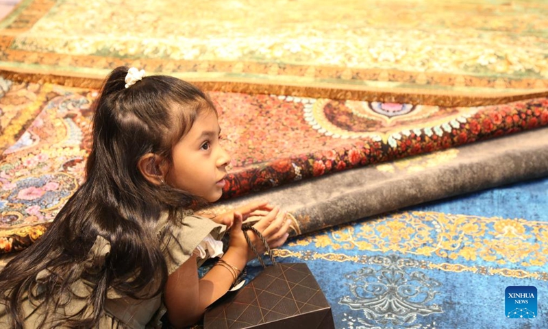 A girl visits the 16th International Floor Coverings, Moquette, Machine-Made Carpet and Related Industries Exhibition in Tehran, Iran, Oct. 17, 2024. The exhibition was held in Tehran from Monday to Thursday. (Photo: Xinhua)