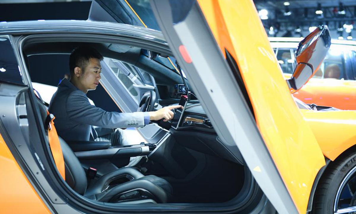 A staff member of Chinese automaker GAC Group debugs an electric sports car during the 2024 World Intelligent Connected Vehicles Conference in Beijing, capital of China, Oct. 17, 2024. Photo: Xinhua