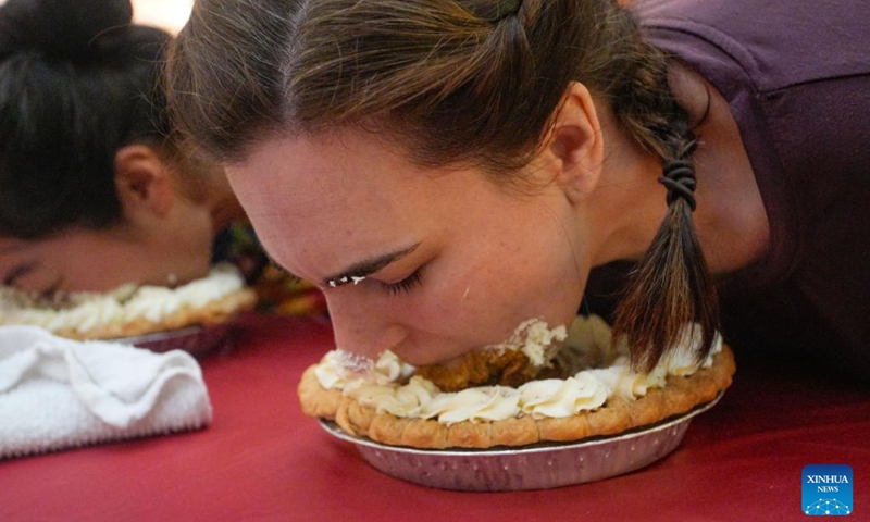 People compete during the pumpkin pie eating contest at Metrotown Shopping Mall in Burnaby, British Columbia, Canada, Oct. 19, 2024.

The competition required participants to finish as much of a 2-pound pie as possible in 5 minutes without using their hands. (Photo: Xinhua)