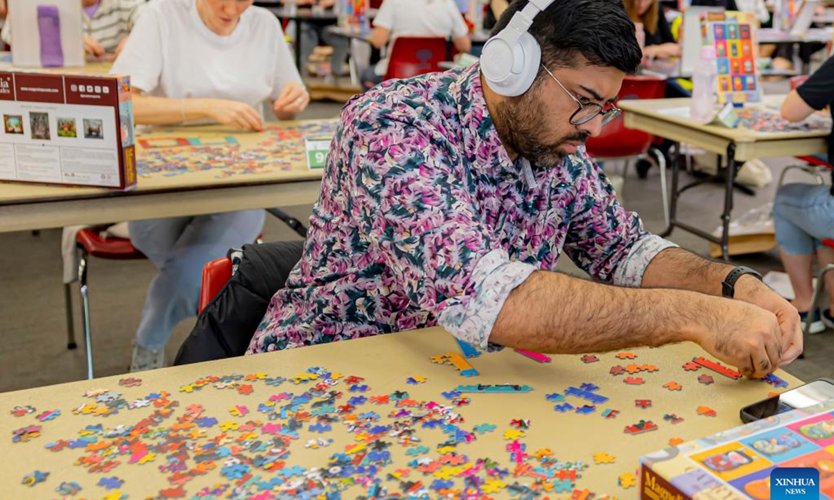 A competitor competes in the Australian Capital Territory (ACT) State Jigsaw Puzzle Competition in Canberra, Australia, Oct. 19, 2024. The first ACT State Jigsaw Puzzle Competition was held in Canberra by the Australian Jigsaw Puzzle Association on Saturday. (Photo: Xinhua)