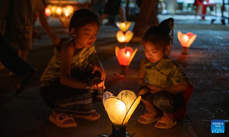 People celebrate the Boun Lai Heua Fai Festival in Luang Prabang, Laos, on Oct. 18, 2024. During the Boun Lai Heua Fai festival, people adorned the city with lanterns, paraded with and later floated large dragon boats and small boats made from banana trees carrying flowers, incense and candles down the Mekong River to let bad luck drift away and good luck flow in.  (Photo: Xinhua)