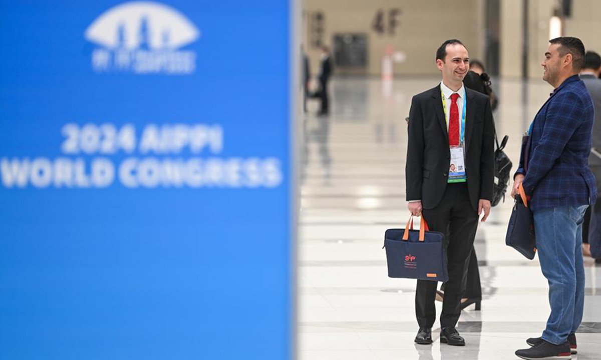 Participants communicate at the venue of the 2024 International Association for the Protection of Intellectual Property (AIPPI) World Congress in Hangzhou, east China's Zhejiang Province, Oct. 19, 2024. (Photo: Xinhua)