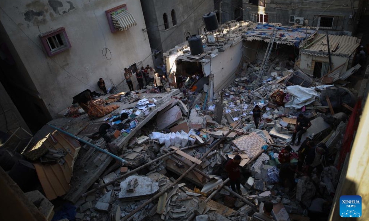 Palestinians check a destroyed house after Israeli attacks in the Al-Maghazi refugee camp in central Gaza Strip, Oct. 19, 2024.

The Palestinian death toll from ongoing Israeli attacks in the Gaza Strip has risen to 42,519, Gaza-based health authorities said in a statement on Saturday. (Photo: Xinhua)