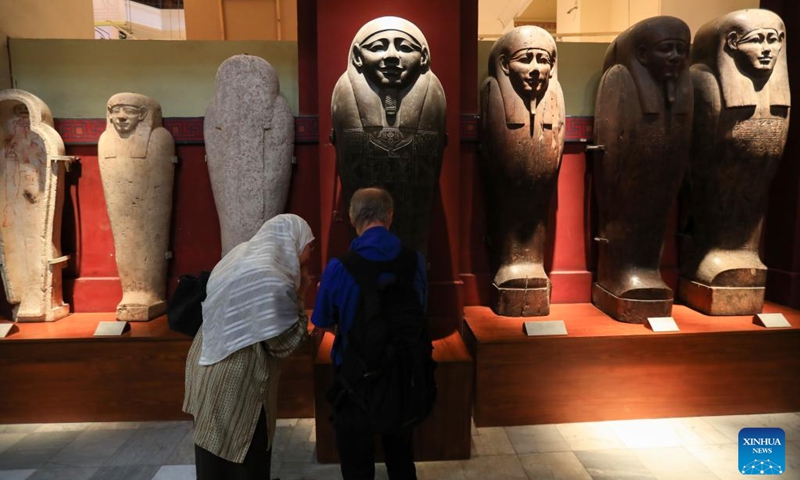 Tourists look at stone mummy coffin lids at Egyptian Museum in Cairo, Egypt, on Oct. 18, 2024. Egypt has entered its peak tourism season as the weather becomes cooler.  (Photo: Xinhua)