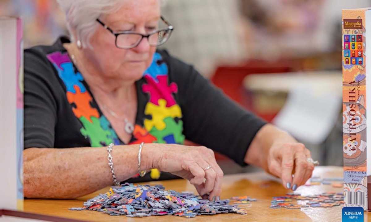 A competitor competes in the Australian Capital Territory (ACT) State Jigsaw Puzzle Competition in Canberra, Australia, Oct. 19, 2024. The first ACT State Jigsaw Puzzle Competition was held in Canberra by the Australian Jigsaw Puzzle Association on Saturday. (Photo: Xinhua)