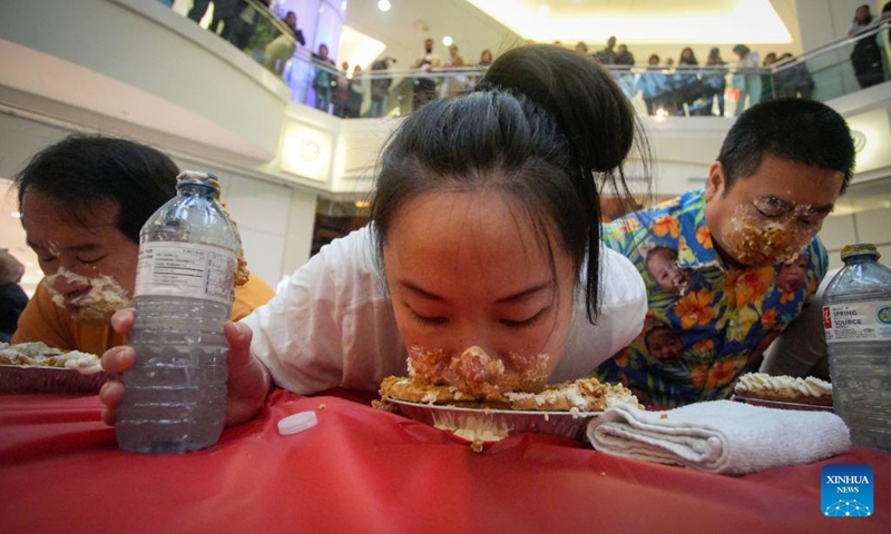 People compete during the pumpkin pie eating contest at Metrotown Shopping Mall in Burnaby, British Columbia, Canada, Oct. 19, 2024.

The competition required participants to finish as much of a 2-pound pie as possible in 5 minutes without using their hands. (Photo: Xinhua)