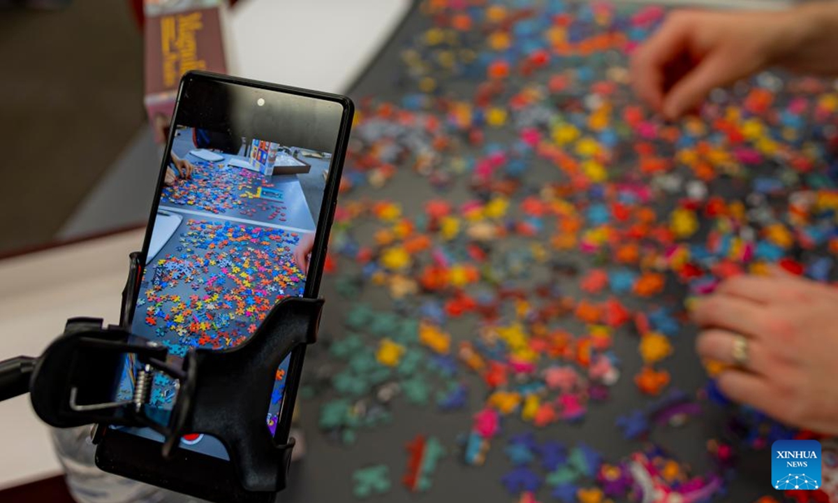 A competitor competes in the Australian Capital Territory (ACT) State Jigsaw Puzzle Competition in Canberra, Australia, Oct. 19, 2024. The first ACT State Jigsaw Puzzle Competition was held in Canberra by the Australian Jigsaw Puzzle Association on Saturday. (Photo: Xinhua)