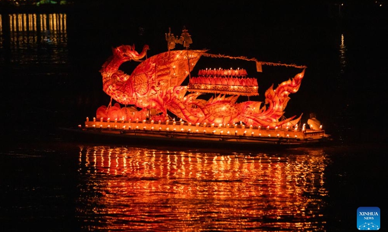 This photo taken on Oct. 18, 2024 shows a light boat floating down the Mekong River in Luang Prabang, Laos. During the Boun Lai Heua Fai festival, people adorned the city with lanterns, paraded with and later floated large dragon boats and small boats made from banana trees carrying flowers, incense and candles down the Mekong River to let bad luck drift away and good luck flow in.  (Photo: Xinhua)