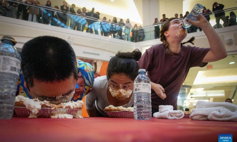 People compete during the pumpkin pie eating contest at Metrotown Shopping Mall in Burnaby, British Columbia, Canada, Oct. 19, 2024.

The competition required participants to finish as much of a 2-pound pie as possible in 5 minutes without using their hands. (Photo: Xinhua)