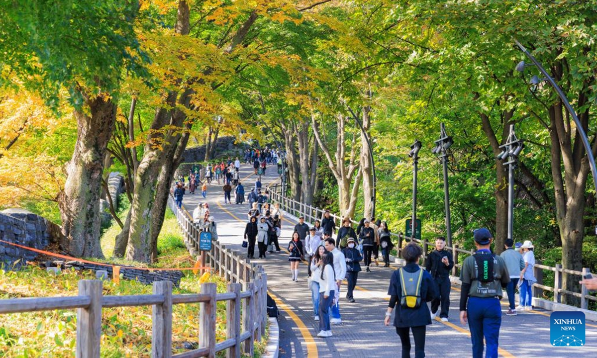 People enjoy the autumn scenery at Namsan Park in Seoul, South Korea, Oct. 20, 2024.   (Photo: Xinhua)