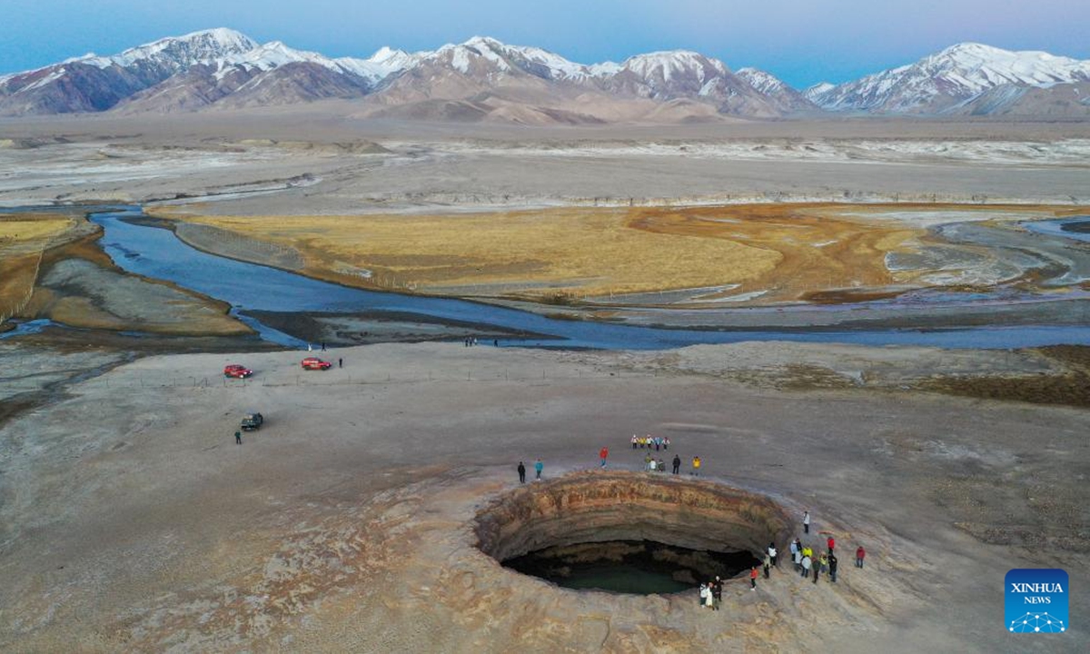 An aerial drone photo taken on Oct. 19, 2024 shows people viewing a volcano crater in Muji Township of Akto County, Kirgiz Autonomous Prefecture of Kizilsu in northwest China's Xinjiang Uygur Autonomous Region. A multidisciplinary scientific expedition was launched on Saturday in Atux City in Xinjiang. (Photo: Xinhua)