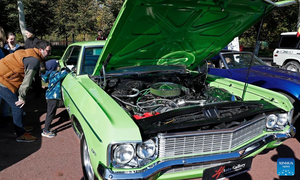 People view a Chevrolet Impala vintage car during the Autumn Retro Parade in Bucharest, Romania, Oct. 20, 2024.    (Photo: Xinhua)