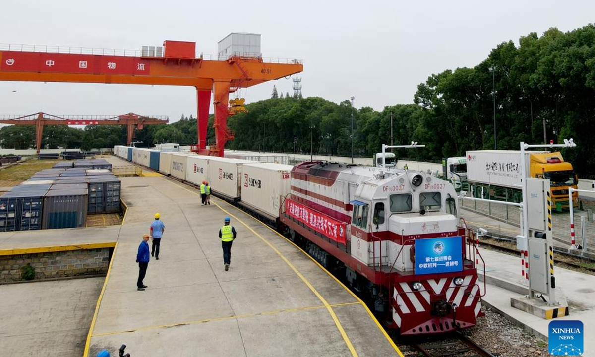 An aerial drone photo shows this year's first Jinbo China-Europe freight train pulling in the Minhang Station in Shanghai, east China, Oct. 20, 2024.

The first Jinbo China-Europe freight train carrying exhibits for the 7th China International Import Expo (CIIE) arrived at the Minhang Station in Shanghai on Sunday, marking the fourth consecutive year that CIIE exhibition products have been transported to Shanghai via the China-Europe freight train service.  (Photo: Xinhua)