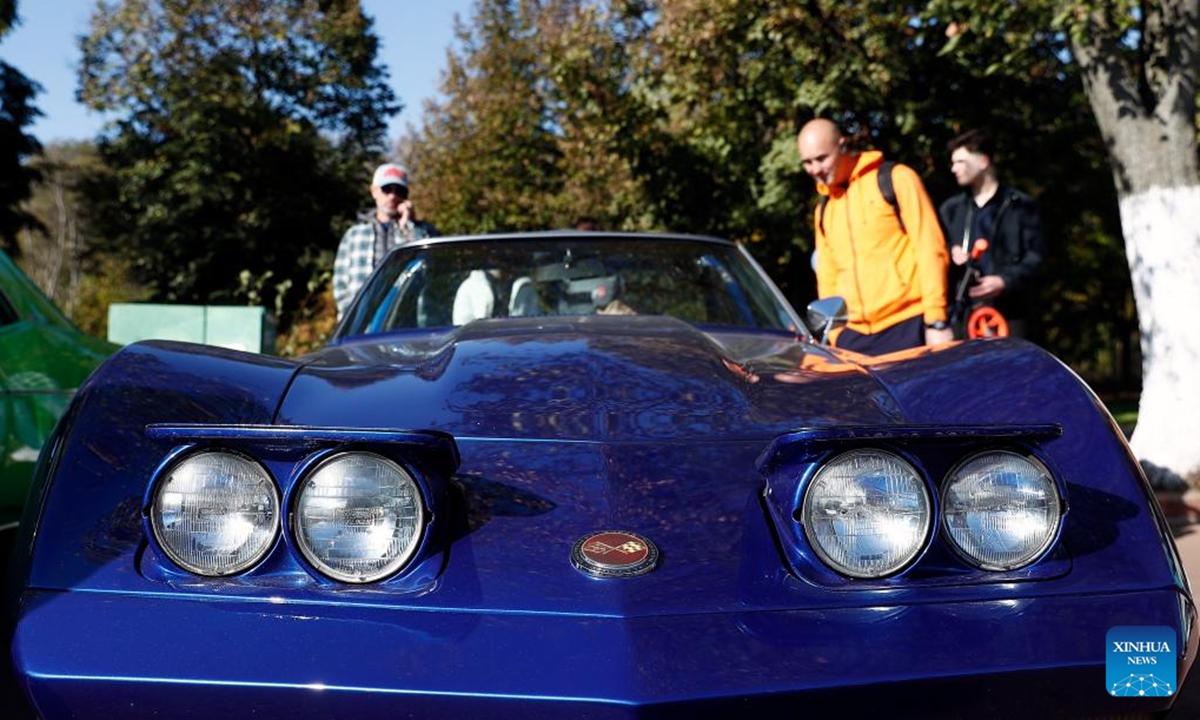 People view a Chevrolet Corvette vintage car during the Autumn Retro Parade in Bucharest, Romania, Oct. 20, 2024.   (Photo: Xinhua)