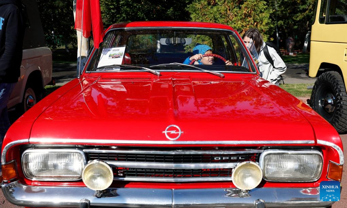 People view a Chevrolet Impala vintage car during the Autumn Retro Parade in Bucharest, Romania, Oct. 20, 2024.     (Photo: Xinhua)