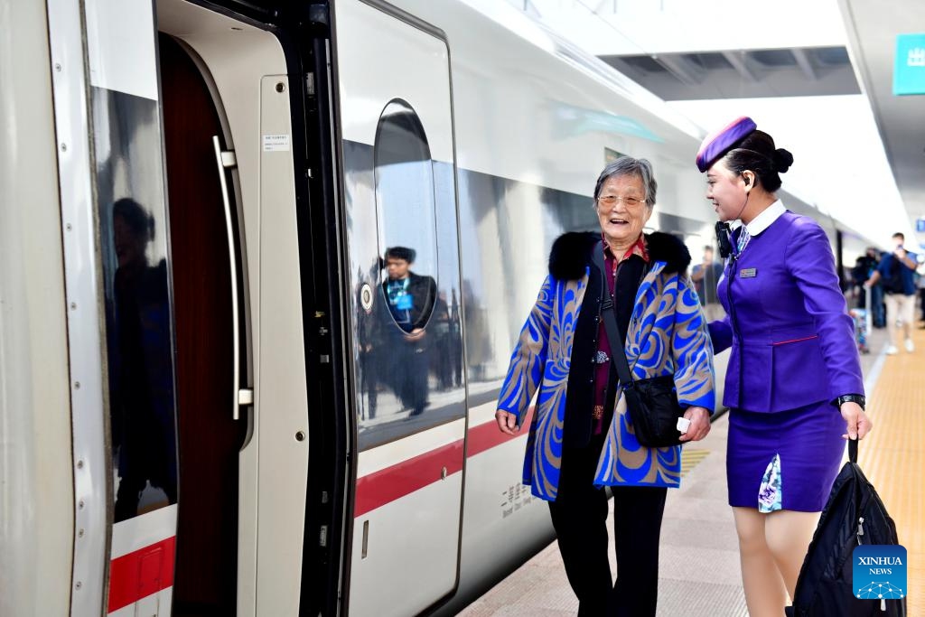 A crew member helps a senior passenger get on the train G9227, the first train of the Weifang-Yantai high-speed railway, at Laizhou Railway Station in east China's Shandong Province, Oct. 21, 2024. The Weifang-Yantai high-speed railway was put into operation on Monday, increasing the total operational length of high-speed railway in Shandong to 3,047 kilometers. (Photo: Xinhua)