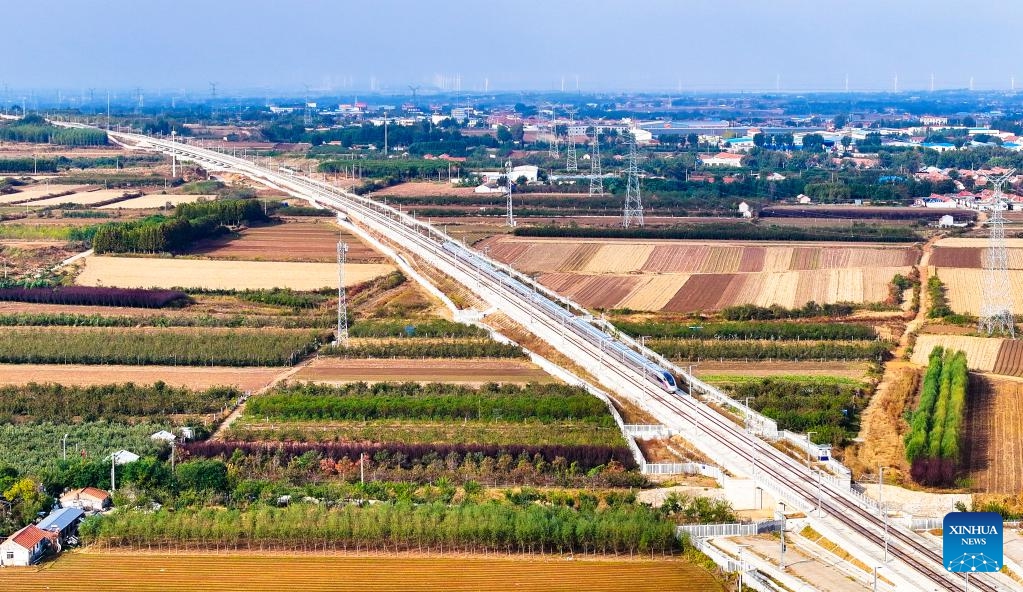 An aerial drone photo taken on Oct. 21, 2024 shows bullet train G9227 arriving at Laizhou Railway Station in east China's Shandong Province. The Weifang-Yantai high-speed railway was put into operation on Monday, increasing the total operational length of high-speed railway in Shandong to 3,047 kilometers. (Photo: Xinhua)