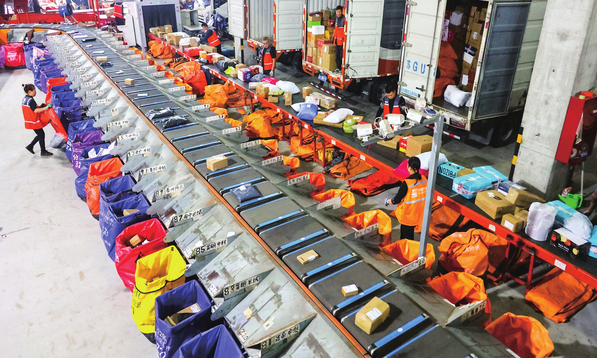 Workers sort express parcels in Lianyungang, East China's Jiangsu Province on October 22, 2024. China's 