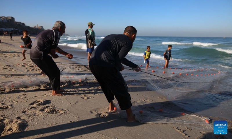 Palestinian fishermen work on the seashore in the city of Deir al-Balah, in the central Gaza Strip, on Oct. 20, 2024. (Photo: Xinhua)