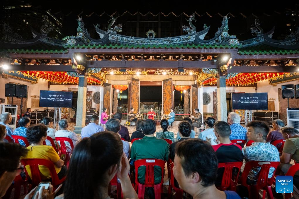 People enjoy a Nanyin concert performed by Siong Leng Musical Association at the Thian Hock Keng Temple, Singapore, Oct. 21, 2024. Nanyin is a genre of traditional Chinese folk music that originated from east China's Fujian Province. (Photo: Xinhua)