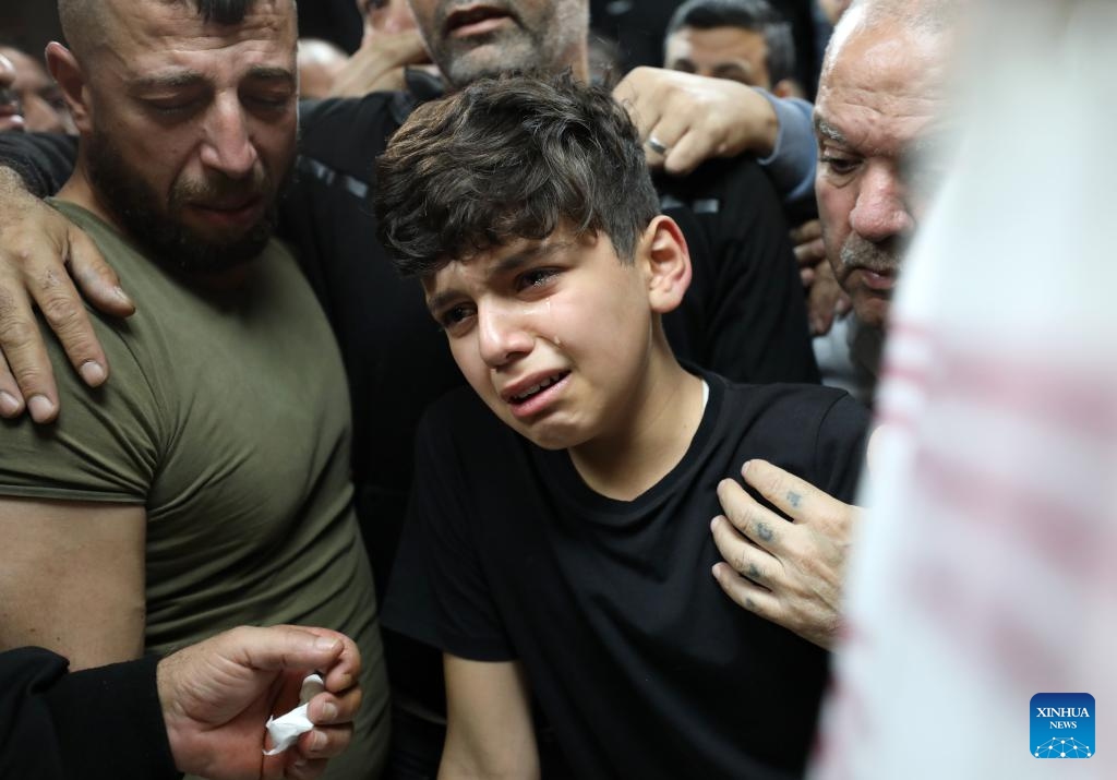 People mourn Palestinian boy Abdullah Hawash during his funeral in the West Bank city of Nablus, on Oct. 22, 2024. The Palestinian child was killed by Israeli forces in the city of Nablus in northern West Bank, Palestinian sources said Tuesday. (Photo: Xinhua)