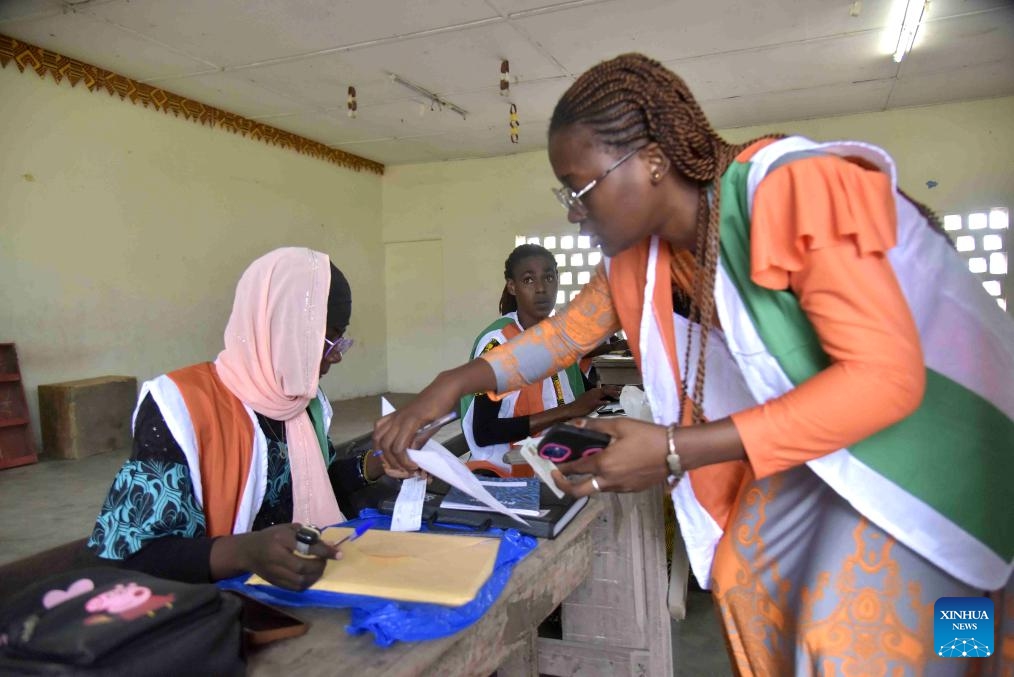 Staff members register information for voters at a voter registration center in Abidjan, Cote d'Ivoire, on Oct. 22, 2024. The revision of the electoral list in Cote d'Ivoire started on Oct. 19 in preparation for next year's presidential election. The Independent Electoral Commission (CEI) forecasts that about 4.5 million new applicants will register by the end of the revision operation, which runs from Oct. 19 through Nov. 10. (Photo: Xinhua)