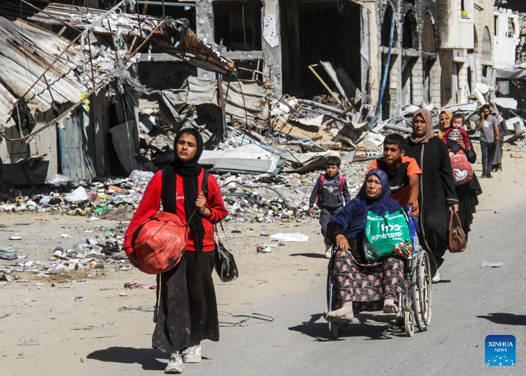 People fleeing from the northern Gaza Strip town of Beit Lahia are seen on a street in Gaza City, on Oct. 22, 2024. Seven Palestinians were killed in an Israeli airstrike on a school sheltering displaced people in Beit Lahia, northern Gaza Strip, according to Palestinian sources on Tuesday. (Photo: Xinhua)