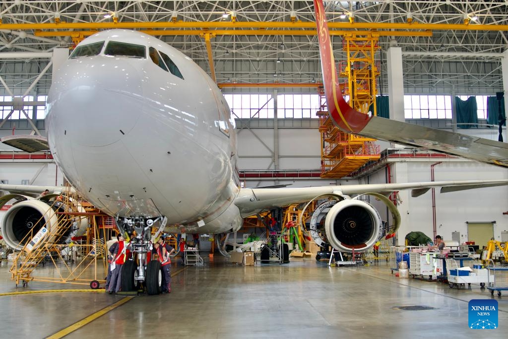 Workers of HNA Technic maintain an inbound airplane at the one-stop aircraft maintenance base of Hainan Free Trade Port in Haikou, south China's Hainan Province, Oct. 21, 2024. Inbound airplanes in Hainan are eligible for preferential treatments of the free trade port including exemption of cash deposite as well as duty-free fuel and maintenance supplies. (Photo: Xinhua)