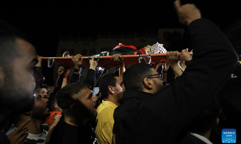 People carry the body of Palestinian boy Abdullah Hawash during his funeral in the West Bank city of Nablus, on Oct. 22, 2024. The Palestinian child was killed by Israeli forces in the city of Nablus in northern West Bank, Palestinian sources said Tuesday. (Photo: Xinhua)