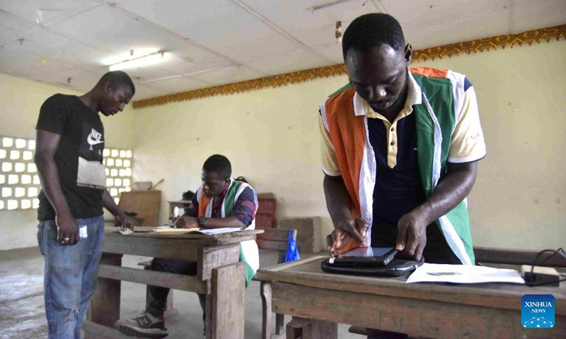 Staff members register information for voters at a voter registration center in Abidjan, Cote d'Ivoire, on Oct. 22, 2024. The revision of the electoral list in Cote d'Ivoire started on Oct. 19 in preparation for next year's presidential election. The Independent Electoral Commission (CEI) forecasts that about 4.5 million new applicants will register by the end of the revision operation, which runs from Oct. 19 through Nov. 10. (Photo: Xinhua)