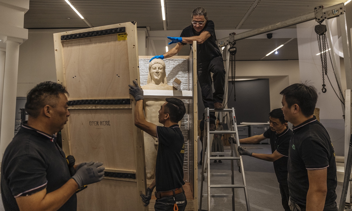 Staff members at the National Museum of China unpack a Greek statue. Photo: Li Hao/GT