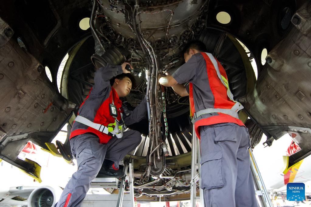 Workers of HNA Technic maintain an inbound airplane at the one-stop aircraft maintenance base of Hainan Free Trade Port in Haikou, south China's Hainan Province, Oct. 21, 2024. Inbound airplanes in Hainan are eligible for preferential treatments of the free trade port including exemption of cash deposite as well as duty-free fuel and maintenance supplies. (Photo: Xinhua)