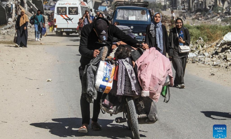 People fleeing from the northern Gaza Strip town of Beit Lahia are seen on a street in Gaza City, on Oct. 22, 2024. Seven Palestinians were killed in an Israeli airstrike on a school sheltering displaced people in Beit Lahia, northern Gaza Strip, according to Palestinian sources on Tuesday. (Photo: Xinhua)