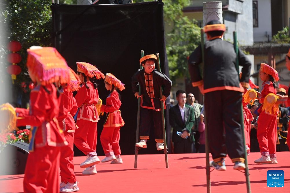 Teenagers of Yao ethnic group perform on stilts at a square in Changping Yao Township in Mengshan County, Wuzhou City, south China's Guangxi Zhuang Autonomous Region, Oct. 23, 2024. Various cultural activities have boosted the unity and common development of all ethnic groups in Mengshan. (Photo: Xinhua)